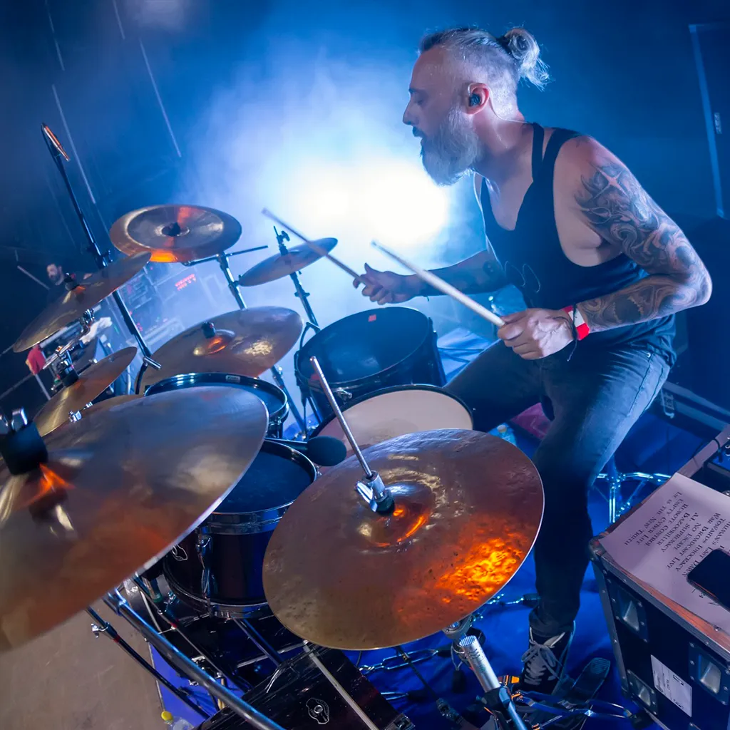 Santi Arroyo GoG performing live on stage as professional metal drummer